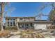 Two-story house with a white garage door and landscaped yard at 5760 S Geneva St, Greenwood Village, CO 80111