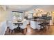 Eat-in kitchen with white cabinets, granite island, and stainless steel appliances at 5760 S Geneva St, Greenwood Village, CO 80111