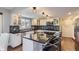 Modern kitchen with white cabinets, granite island, and stainless steel appliances at 5760 S Geneva St, Greenwood Village, CO 80111