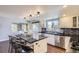 Updated kitchen with white cabinets, black countertops, and an island at 5760 S Geneva St, Greenwood Village, CO 80111