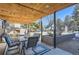 Covered patio with outdoor fireplace and seating area at 5760 S Geneva St, Greenwood Village, CO 80111