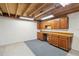 Unfinished basement with built-in workbench and cabinets at 15037 E Carolina Pl, Aurora, CO 80012