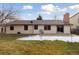 Back exterior of the house with a patio and landscaping at 15037 E Carolina Pl, Aurora, CO 80012