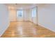 Finished basement with recessed lighting, two windows, and beautiful hardwood floors at 3466 Craftsbury Dr, Highlands Ranch, CO 80126