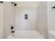 Modern bath/shower combo boasts decorative tile and dark fixtures in a bright, naturally lit setting at 3466 Craftsbury Dr, Highlands Ranch, CO 80126
