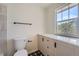 Compact bathroom with white cabinets, quartz countertop, and black hardware, blending functionality with contemporary style at 3466 Craftsbury Dr, Highlands Ranch, CO 80126