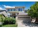 Beautiful two-story home with a two car garage, manicured lawn, brick accents and attractive landscaping at 3466 Craftsbury Dr, Highlands Ranch, CO 80126