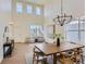 Sun-filled open-concept living room with a two-story ceiling, modern lighting and many windows at 3466 Craftsbury Dr, Highlands Ranch, CO 80126