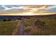 Peaceful park setting with a bench overlooking a neighborhood and golden sunset at 3466 Craftsbury Dr, Highlands Ranch, CO 80126