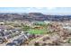 An aerial view shows a community near parks and athletic fields with a mountain backdrop at 1263 S Gilbert St, Castle Rock, CO 80104