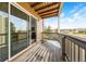 Cozy covered balcony with wooden deck and railing, offering peaceful views of the natural scenery at 1263 S Gilbert St, Castle Rock, CO 80104