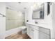 Clean, well-lit bathroom features a shower-tub combo with glass doors and a modern vanity at 1263 S Gilbert St, Castle Rock, CO 80104