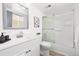 Clean bathroom features a vanity, a mirror, and a tub-shower combination with sliding glass doors at 1263 S Gilbert St, Castle Rock, CO 80104