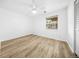 Bright bedroom featuring wood-look floors, a ceiling fan, and ample natural light from the window at 1263 S Gilbert St, Castle Rock, CO 80104