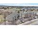 A building with multiple levels and balconies overlooks a road with mountains in the distance at 1263 S Gilbert St, Castle Rock, CO 80104
