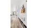 Hallway with hardwood floors and a wall bench with storage leading into a bright living space at 1263 S Gilbert St, Castle Rock, CO 80104
