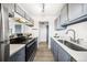 Bright kitchen featuring stainless appliances, gray cabinets and a large sink with modern faucet at 1263 S Gilbert St, Castle Rock, CO 80104
