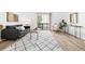 Bright, airy living room featuring neutral decor, hardwood floors, and sliding glass doors to a balcony at 1263 S Gilbert St, Castle Rock, CO 80104