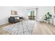Bright living room with a neutral color palette, wood floors, and a large sliding door to a private balcony at 1263 S Gilbert St, Castle Rock, CO 80104