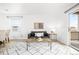 Bright living room features a gray couch, hardwood floors, stylish rug, and sliding glass door at 1263 S Gilbert St, Castle Rock, CO 80104