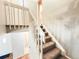 Carpeted staircase with white railing leading to the upper level of the home at 1120 S Waco St # A, Aurora, CO 80017
