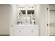 Elegant bathroom featuring a double vanity, sleek lighting, and contemporary design at 46517 Sunflower Ln, Bennett, CO 80102