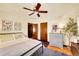 Comfortable bedroom with hardwood floors, ceiling fan, and a stylish dresser with decor at 963 N Logan St # 2, Denver, CO 80203