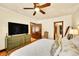 Well-lit bedroom offers hardwood floors, a ceiling fan, and easy access to an en-suite bathroom at 963 N Logan St # 2, Denver, CO 80203