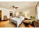 Cozy bedroom with a vintage chair, hardwood floors, and elegant lamps at 963 N Logan St # 2, Denver, CO 80203