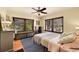Bright bedroom with large windows, ceiling fan, hardwood floors, and ample natural light at 963 N Logan St # 2, Denver, CO 80203