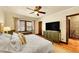 Spacious bedroom boasts hardwood floors, a ceiling fan, and access to another room at 963 N Logan St # 2, Denver, CO 80203