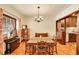 Formal dining area with wood floors and a vintage chandelier, adjacent to the kitchen at 963 N Logan St # 2, Denver, CO 80203