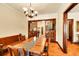 Elegant dining room features vintage chandelier, natural light and decorative room divider with ornate woodwork at 963 N Logan St # 2, Denver, CO 80203