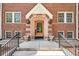 Inviting brick entryway with a detailed archway door and decorative sconces at 963 N Logan St # 2, Denver, CO 80203