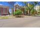 Classic brick apartment building on a sunny day, showcasing its street-side charm and landscaping at 963 N Logan St # 2, Denver, CO 80203