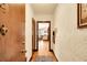 Hallway leading to living area with wood floors, textured walls, and vintage charm at 963 N Logan St # 2, Denver, CO 80203