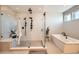 Beautiful bathroom with a large shower, a soaking tub, and modern fixtures at 14209 Beebalm Loop, Parker, CO 80134