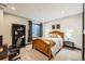 Cozy bedroom features a light-wood bed frame, a window, and neutral decor at 14209 Beebalm Loop, Parker, CO 80134