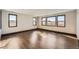 Bright bonus room featuring wood floors, large windows, and neighborhood views at 14209 Beebalm Loop, Parker, CO 80134