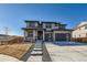 Striking two-story home featuring a modern design, stone accents, and a well-manicured front yard at 14209 Beebalm Loop, Parker, CO 80134