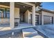 Close-up of the front entrance highlighting the modern door, stone accents, and covered porch at 14209 Beebalm Loop, Parker, CO 80134