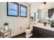 Stylish half bathroom with modern fixtures, elegant decor, and natural light at 14209 Beebalm Loop, Parker, CO 80134