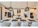 Modern kitchen with a large island, stylish pendant lighting, and stainless steel appliances at 14209 Beebalm Loop, Parker, CO 80134