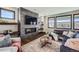 Cozy living room featuring a modern fireplace, large windows, and comfortable seating at 14209 Beebalm Loop, Parker, CO 80134