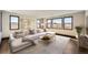 Bright living room with large windows, modern shelving, and comfortable sectional sofa at 14209 Beebalm Loop, Parker, CO 80134
