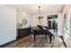 Elegant living area featuring a grand piano, stylish chandelier, and convenient wine storage at 14209 Beebalm Loop, Parker, CO 80134