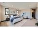 Bright main bedroom featuring a seating area, stylish decor, and plush carpet at 14209 Beebalm Loop, Parker, CO 80134