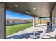 Covered patio offers a pleasant view of the landscaped backyard and neighborhood at 14209 Beebalm Loop, Parker, CO 80134