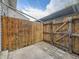 Enclosed backyard area with a wooden fence and paved area, perfect for outdoor activities at 1932 S Oswego Way, Aurora, CO 80014