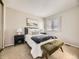 Cozy bedroom with a bed, lamps, art, and a furry blanket at 1932 S Oswego Way, Aurora, CO 80014
